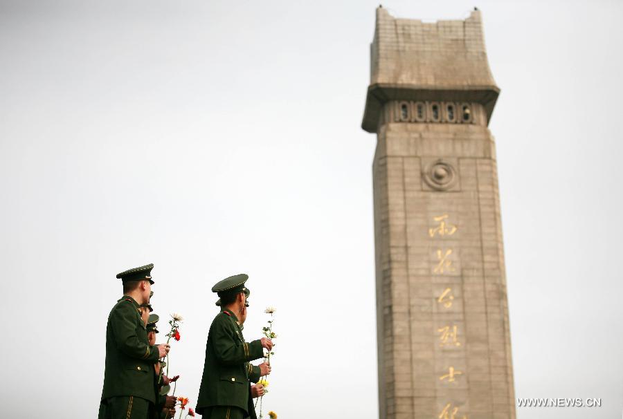 Soldiers present flowers at a monument during a memorial ceremony held at Yuhuatai Martyr Cemetery in Nanjing, capital of east China's Jiangsu Province, March 30, 2013. Various memorial ceremonies were held across the country to pay respect to martyrs ahead of the Qingming Festival, or Tomb Sweeping Day, which falls on April 4 this year. (Xinhua)
