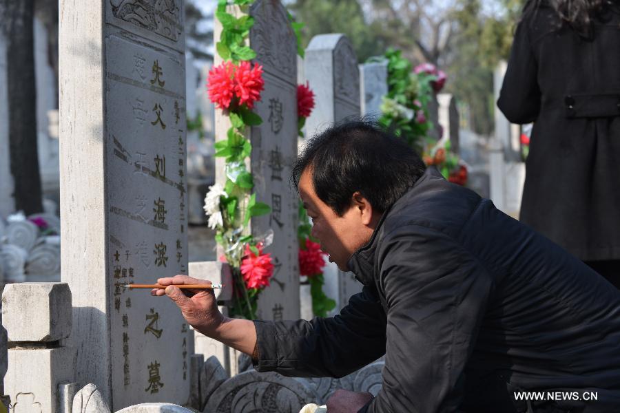 A man refurbishes his family members' tombstone at the Babaoshan People's Cemetery in Beijing, capital of China, March 30, 2013. Citizens have begun to remember and honour their deceased family members and ancestors as the annual Qingming Festival draws near. The Qingming Festival, also known as Tomb Sweeping Day, is usually observed by the Chinese around April 5 each year. (Xinhua/Wang Quanchao)