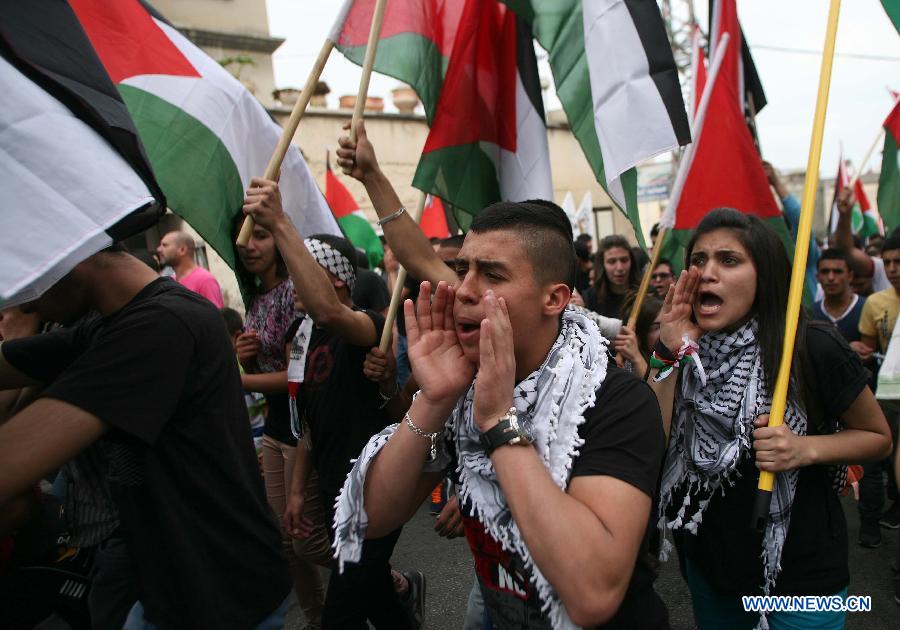 Israeli Arabs shout slogans during a demonstration marking Land Day in Israeli northern town of Sakhnin on March 30, 2013. Land Day is the annual commemoration of protests in 1976 against Israel's appropriation of Arab-owned land in Galilee. (Xinhua/Muammar Awad)