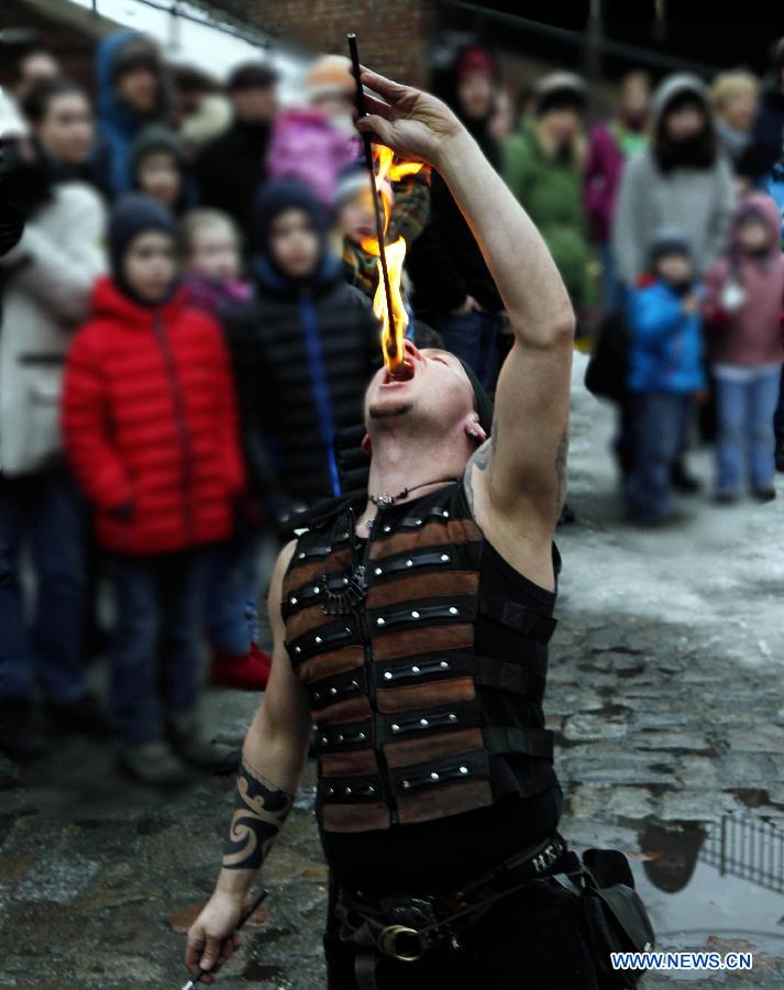 A man shows his stunt of swallowing fire during the annual Knight Festival, which opened in the Spandau Zitadelle (Citadel) in Berlin, March 30, 2013. A wide range of activities presenting the life and scene dating back to the European medieval times at the 3-day Knight Festival attracts many Berliners on outing during their Easter vacation. (Xinhua/Pan Xu)