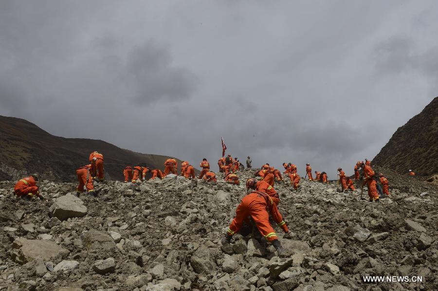 Rescue workers conduct search and rescue work at the site where a large-scale landslide hit a mining area in Maizhokunggar County of Lhasa, southwest China's Tibet Autonomous Region, March 30, 2013. Rescuers have found bodies and are still searching for survivors more than 37 hours after a massive landslide buried 83 miners at the polymetal mine in Tibet. (Xinhua/Purbu Zhaxi)