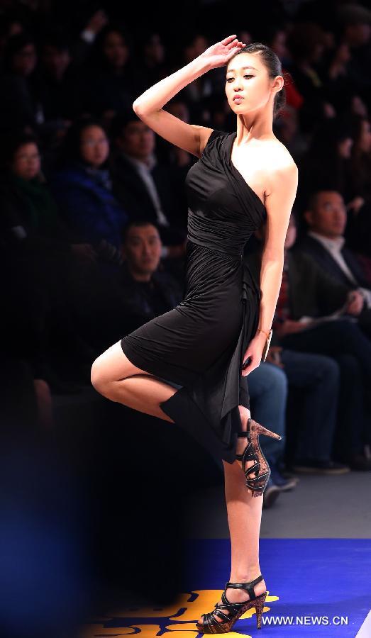 A contestant presents a dress during the 8th China Super Model Final Contest in Beijing, capital of China, March 30, 2013. (Xinhua/Wan Xiang)