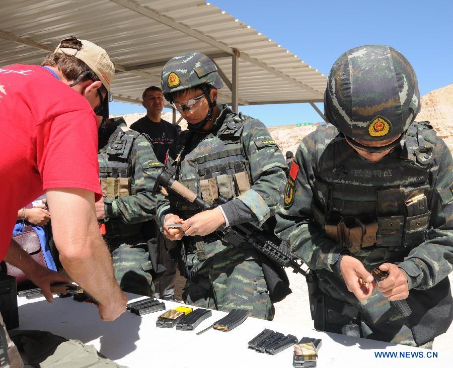 Chinese paramilitary personnels load before the 5th Warrior Competition at King Abdullah Special Operation Training Center (KASOTC) in Amman, capital of Jordan, on March 28, 2013. The competition with wide participation of 33 teams from 18 countries is held from March 24 to March 28. (Xinhua/Cheng Chunxiang)