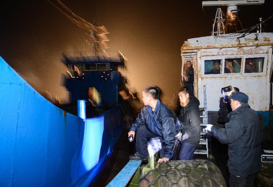 Photo taken on March 29, 2013 shows plain-clothed police trying to get onto a boat of suspect offshore east China's Zhejiang Province. A gangs smuggling case involving 15,000 tons of refined oil worthy over 100 million Yuan (approximately 15.9 million U.S. dollars) was seized here on Sunday, as announced by Hangzhou customs on March 31, it is the biggest ever gangs smuggling case offshore Zhejiang province. (Xinhua/Xu Yu)