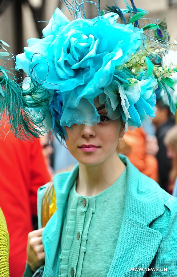 A girl in a bright colored hat participates in the annual Easter Bonnet Parade held on the Fifth Avenue in Manhattan of New York, the United States, March 31, 2013. With a history of more than 100 years, the New York Easter Bonnet Parade is held annually on the 5th Avenue near the Saint Patrick's Cathedral. Adults, children and even pets in creative colorful bonnets and outfits participate in the event, which also attract thousands of New York residents and tourists. (Xinhua/Deng Jian) 