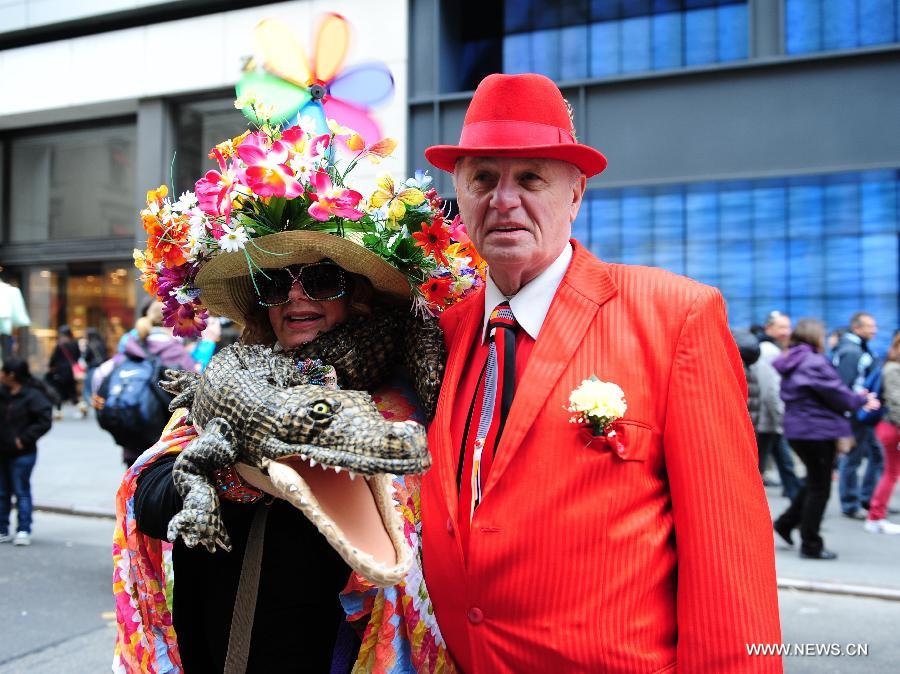 Two participants pose for photos in the annual Easter Bonnet Parade in Manhattan of New York, the United States, March 31, 2013. With a history of more than 100 years, the New York Easter Bonnet Parade is held annually on the 5th Avenue near the Saint Patrick's Cathedral. Adults, children and even pets in creative colorful bonnets and outfits participate in the event, which also attract thousands of New York residents and tourists. (Xinhua/Deng Jian) 