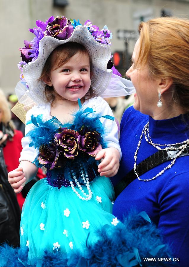 A girl in beautiful costumes takes part in the annual Easter Bonnet Parade with her mother in Manhattan of New York, the United States, March 31, 2013. With a history of more than 100 years, the New York Easter Bonnet Parade is held annually on the 5th Avenue near the Saint Patrick's Cathedral. Adults, children and even pets in creative colorful bonnets and outfits participate in the event, which also attract thousands of New York residents and tourists. (Xinhua/Deng Jian) 