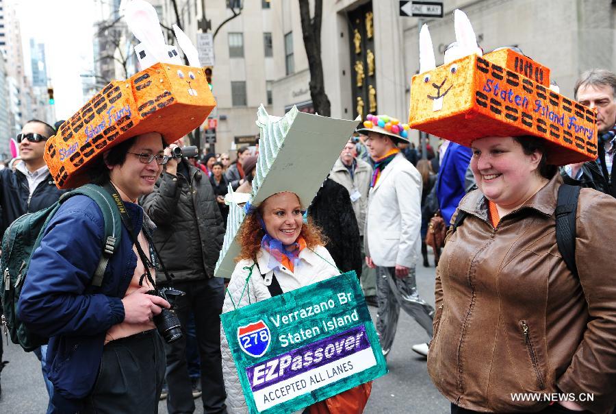 Three people with hats in shapes of ferries and bridge take part in the annual Easter Bonnet Parade held on the Fifth Avenue in Manhattan of New York, the United States, March 31, 2013. With a history of more than 100 years, the New York Easter Bonnet Parade is held annually on the 5th Avenue near the Saint Patrick's Cathedral. Adults, children and even pets in creative colorful bonnets and outfits participate in the event, which also attract thousands of New York residents and tourists. (Xinhua/Deng Jian) 