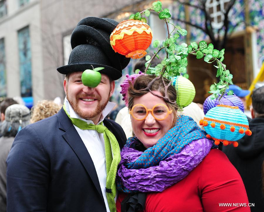 Two participants pose for photos in the annual Easter Bonnet Parade in Manhattan of New York, the United States, March 31, 2013. With a history of more than 100 years, the New York Easter Bonnet Parade is held annually on the 5th Avenue near the Saint Patrick's Cathedral. Adults, children and even pets in creative colorful bonnets and outfits participate in the event, which also attract thousands of New York residents and tourists. (Xinhua/Deng Jian) 