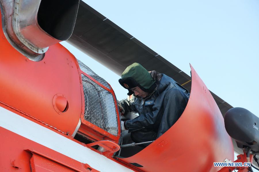 A service crew member checks a helicopter before a flight training to extinguish forest fire in Daqing City, northeast China's Heilongjiang Province, March 28, 2013. As the warm and dry spring season draws near in northern China, the risk of forest fire increases in many places. (Xinhua/Han Xinghua) 