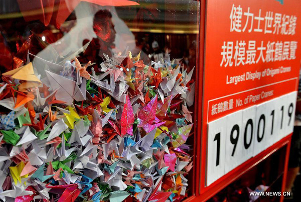 A total of 1,900,119 origami cranes, folded by fans around the world, are displayed inside a giant red cube at an exhibition for paying tribute to late Hong Kong actor Leslie Cheung in Hong Kong, south China, March 30, 2013. The exhibition is held to mark the 10th anniversary of the death of Leslie Cheung, who leapt to his death from a hotel in Hong Kong on April 1, 2003. The display of origami cranes broke the Guinness World Record as "the largest display of origami cranes". (Xinhua/Chen Xiaowei)