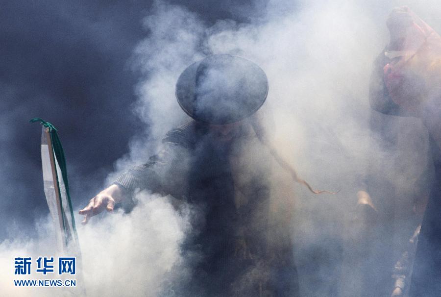 A Jewish man stands in the smoke of burning leaves on March 25, before the coming Passover festival. (Xinhua/Reuters)
