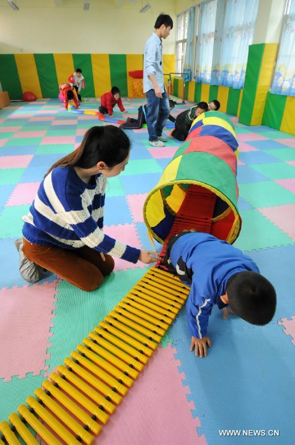 Autistic children are in a sense training at Xingyu School in Fuzhou, capital of southeast China's Fujian Province, April 1, 2013. The Xingyu School, offically opened to public in February this year, is a nine-year compulsory education school founded specifically for autistic children. It combines the characteristics of normal primary schools and autism rehabilitation centers, and provides both linguistic and behavior trainings to autistic children for their better intergration into the society in the future. (Xinhua/Lin Shanchuan)