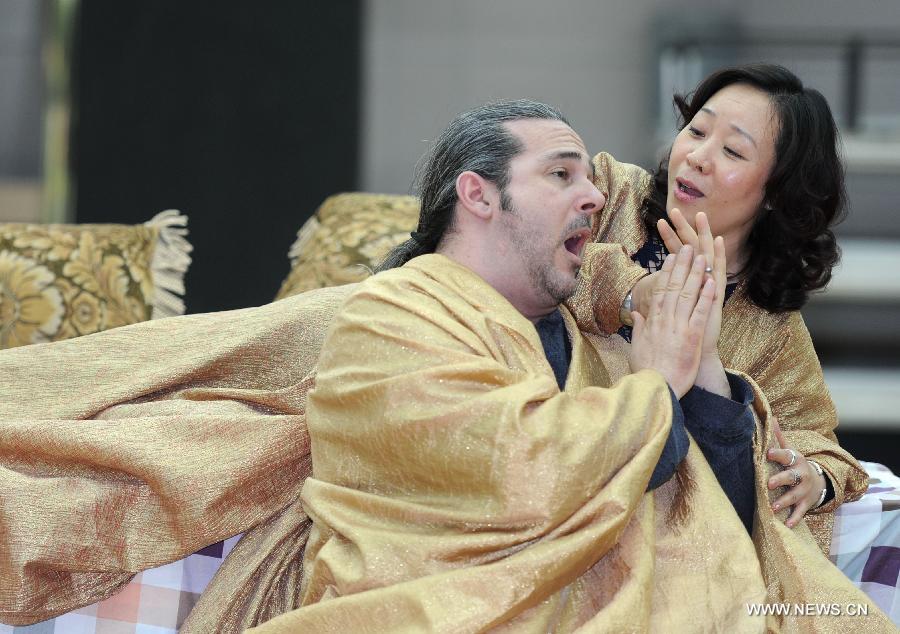 Otello by Frank Porretta (L) and Desdemona by Zhang Liping rehearse Italian opera maestro Giuseppe Verdi's masterpiece "Otello" at the National Center for the Performing Arts (NCPA) in Beijing, capital of China, April 1, 2013. The production will open NCPA's Opera Festival 2013 on April 11. (Xinhua/Luo Xiaoguang)