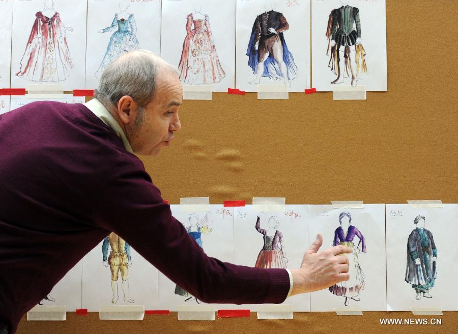 A designer introduces costumes for a production of Italian opera maestro Giuseppe Verdi's masterpiece "Otello", which is in rehearsal, at the National Center for the Performing Arts (NCPA) in Beijing, capital of China, April 1, 2013. The production will open NCPA's Opera Festival 2013 on April 11. (Xinhua/Luo Xiaoguang)