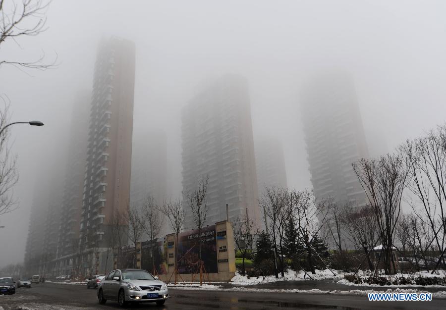 Buildings are shrouded by fog in Shenyang, capital of northeast China's Liaoning Province, April 2, 2013. Local meteorological authorities issued an orange fog alert on Tuesday morning, and the visibility in the city was less than 500 meters. (Xinhua/Jiang Bing)