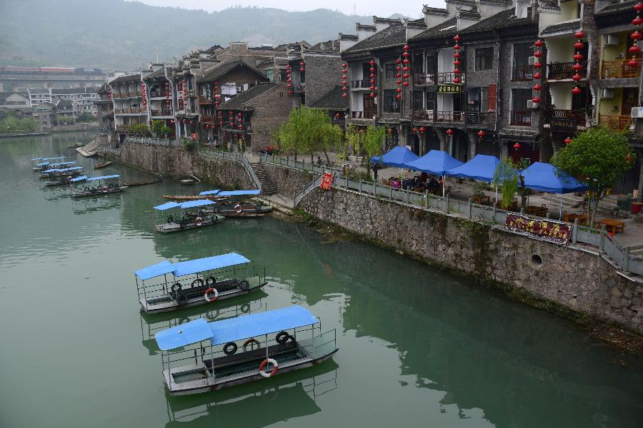 Boats are floated along the riverside in Zhenyuan County, southwest China's Guizhou Province, March 31, 2013. The county could date back 2,280 years with the Wuyang River running through it. As many ancient style architectures were built along the river, the ancient town was dubbed as "Oriental Venice" by tourists. (Xinhua/Hu Yan) 