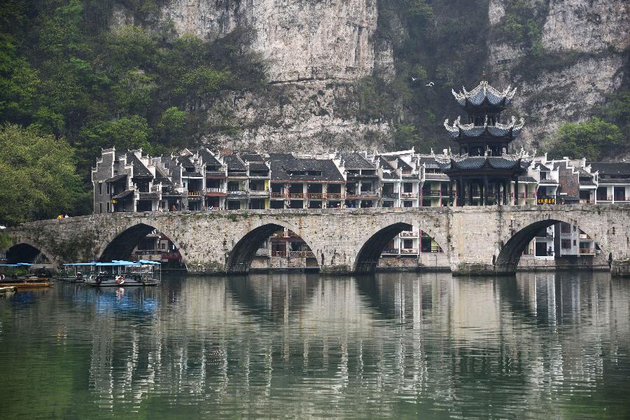 An arch bridge is pictured in Zhenyuan County, southwest China's Guizhou Province, March 31, 2013. The county could date back 2,280 years with the Wuyang River running through it. As many ancient style architectures were built along the river, the ancient town was dubbed as "Oriental Venice" by tourists. (Xinhua/Hu Yan)