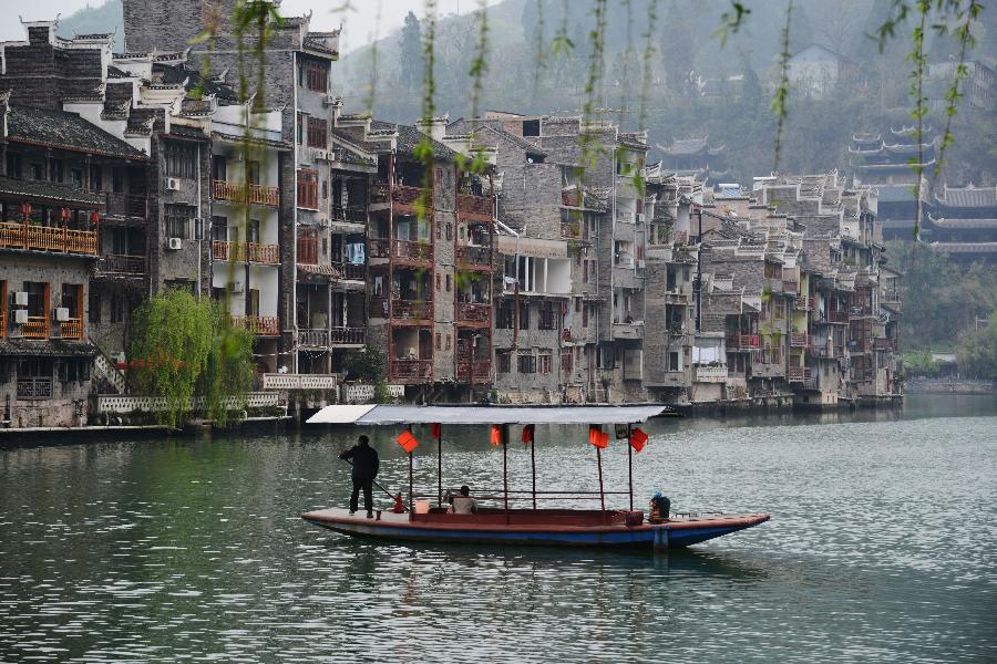 A boatman rows a tourism boat in Zhenyuan County in southwest China's Guizhou Province, March 31, 2013. The county could date back 2,280 years with the Wuyang River running through it. As many ancient style architectures were built along the river, the ancient town was dubbed as "Oriental Venice" by tourists. (Xinhua/Hu Yan)