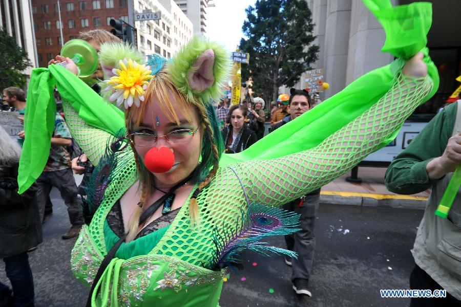 People take part in the annual St. Stupid's Day Parade held at the financial district in San Francisco, the United States, April 1, 2013. The 35th Annual St. Stupid's Day Parade was held on April Fool's Day in San Francisco. (Xinhua/Liu Yilin)