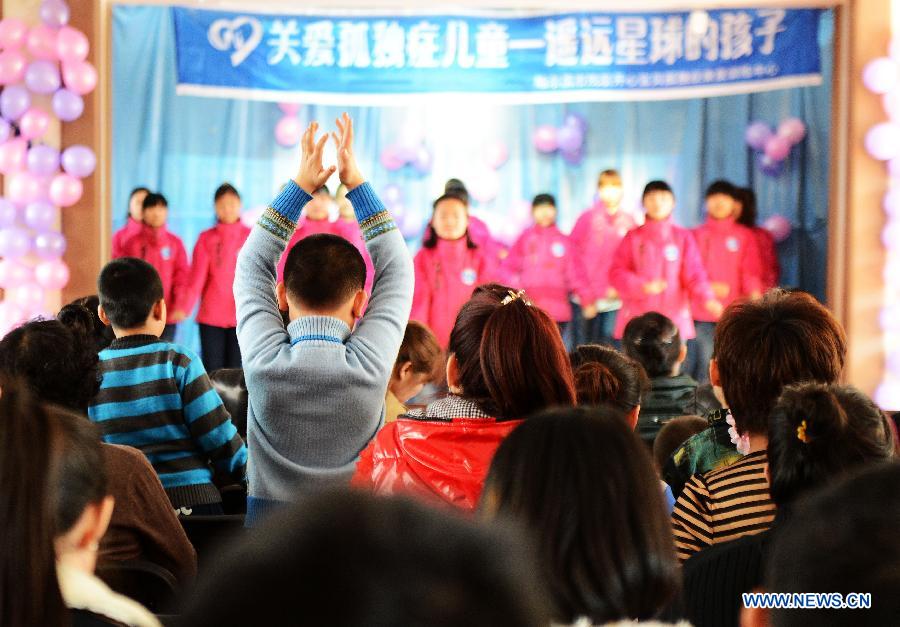 An autistic boy claps as watching a performance at a rehabilitation center for autistic children in Harbin, capital of northeast China's Heilongjiang Province, April 2, 2013, on the occasion of the World Autism Awareness Day. (Xinhua/Wang Kai)