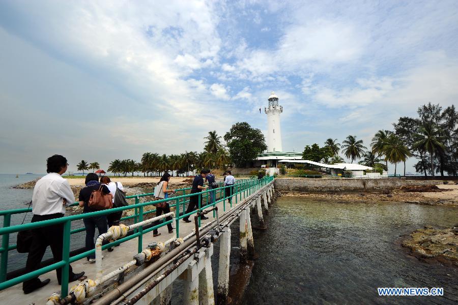 Reporters visit the Raffles Lighthouse on Singapore's southern island of Pulau Satumu, on April 2, 2013. The Maritime Port Authority (MPA) of Singapore organized a visit for the media to the Raffles Lighthouse as a preview of the upcoming Singapore Maritime Week which will be held from April 7 to 12. (Xinhua/Then Chih Wey)