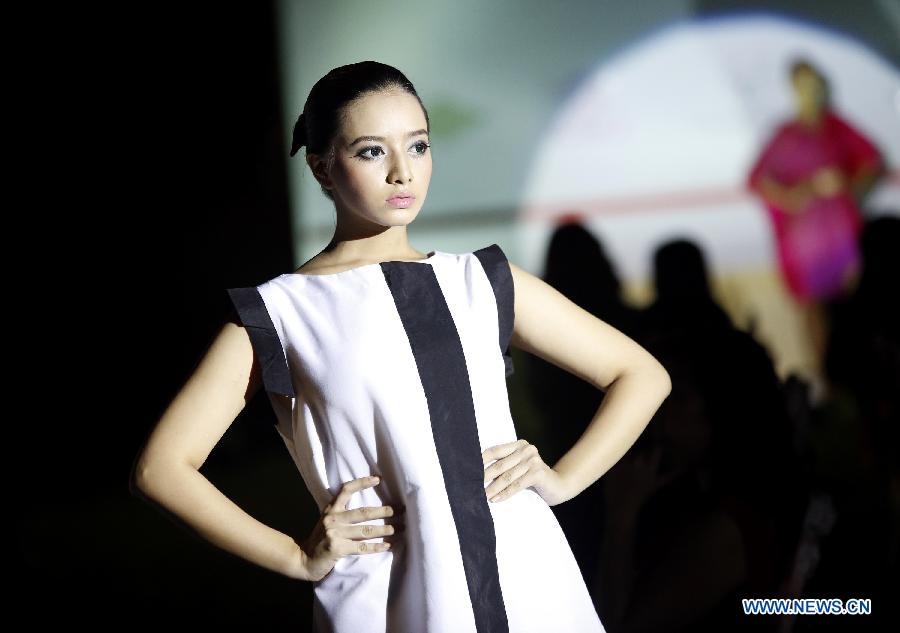 A model presents a creation by Myanmar's Shan designer Mo Hom during the Mon Precieux New York Summer/Winter 2013 Collection show in Yangon, Myanmar, on April 1, 2013. (Xinhua/U Aung)