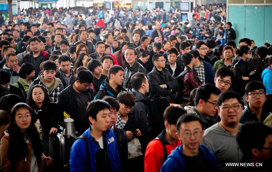 Passengers wait to board on trains at the Tianjian Railway Station in Tianjin Municipality, north China, April 3, 2013. The railway station witnessed a travel peak on Wednesday, ahead of the country's three-day holiday for tomb sweeping, which will start on April 4. (Xinhua/Zhang Chaoqun)