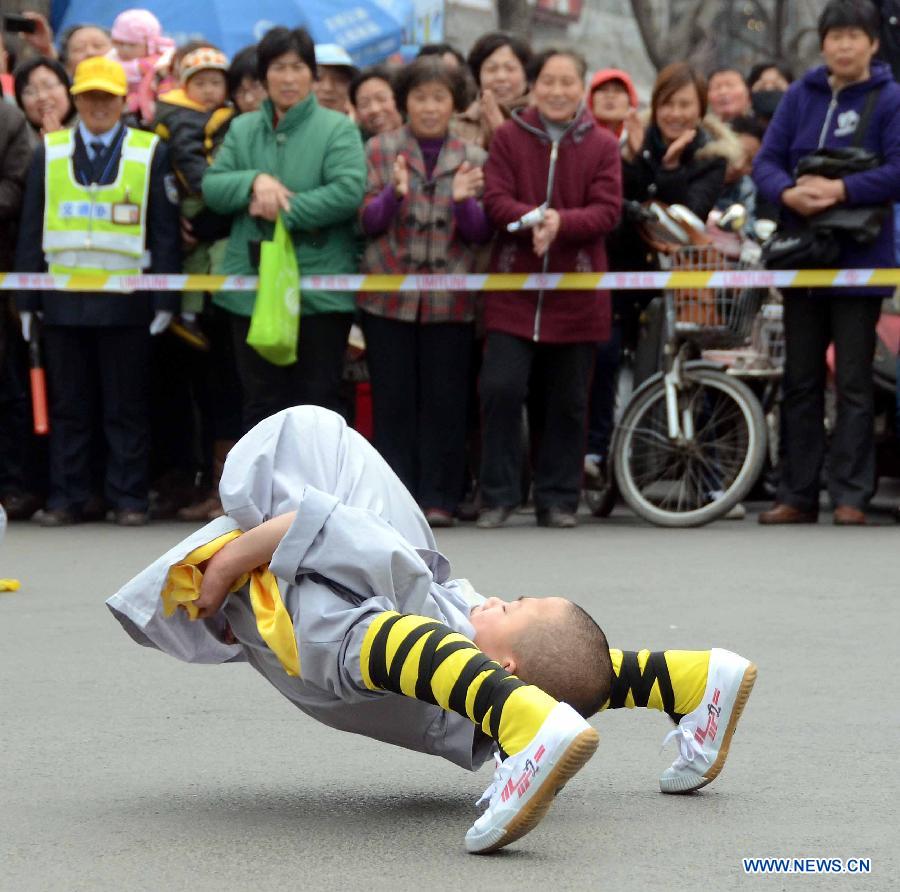 A little monk performs Kung fu during a spring parade for the upcoming Tomb-sweeping Day in Kaifeng, central China's Henan Province, April 3, 2013. Thousands of performers and citizens participated in the parade. (Xinhua/Wang Song) 