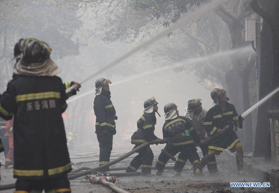 Firemen put out a fire at the Zhangwan Farmers Market in Shiyan City, central China's Hubei Province, April 3, 2013. The fire broke out around 2:20 p.m. at the market and was put out later, leaving one person injured. (Xinhua)