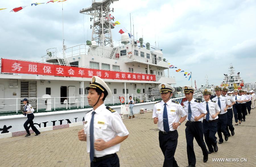 Staff members head to the board of the patrol vessel "Haixun 21" in Haikou, capital of south China's Hainan Province, April 3, 2013. A fleet of five marine surveillance ships will monitor maritime traffic safety, investigate maritime accidents, detect pollution, and carry out other missions around the clock during the Boao Forum for Asia Annual Conference 2013 in Hainan. (Xinhua/Zhao Yingquan)