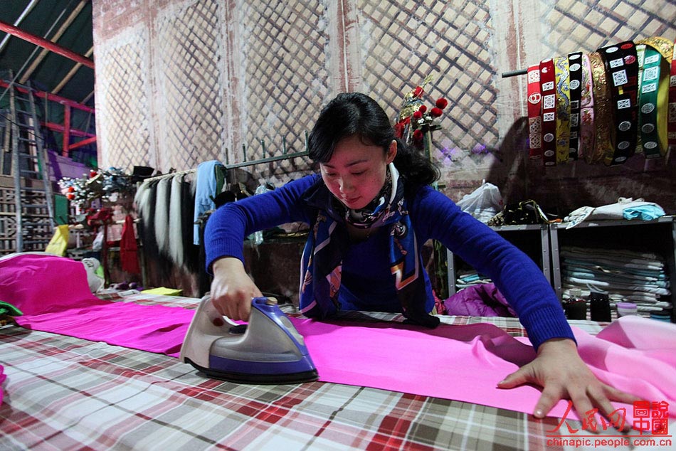 Yang Xiayun irons a piece of dress that would be used in the performance to be held in Latin America. After years of training, Yang has surpassed many peers and became the mainstay of the troupe, which introduces Chinese folk art to more foreign audience.