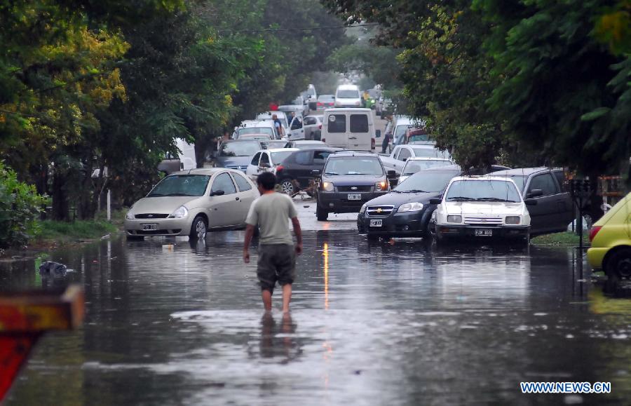 A man walks in a flooded area, after a storm, in La Plata, 63 km south of Buenos Aires, Argentina, on April 3, 2013. (Xinhua/TELAM) 