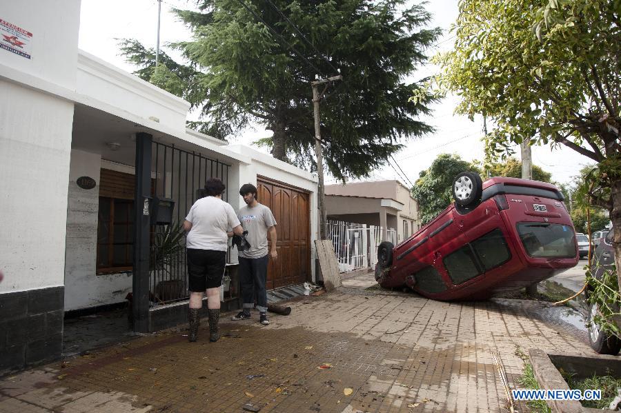 A car is turned over by flood in La Plata, 63 km south of Buenos Aires, Argentina, on April 3, 2013. At least 46 people have died due to heavy storms in La Plata, and another 3,000 have been evacuated, according to local media. (Xinhua/Martin Zabala) 