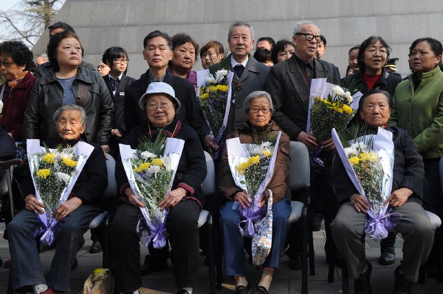 Survivors and family members of the victims of the Nanjing Massacre in 1937 attend a memorial ceremony in the Memorial Hall of the Victims in Nanjing Massacre by Japanese Invaders, in Nanjing, capital of east China's Jiangsu Province, April 4, 2013, also the Qingming Festival, or the Tomb-Sweeping Day. Lots of citizens came here to mourn Nanjing Massacre victims on Thursday. (Xinhua/Han Yuqing)  