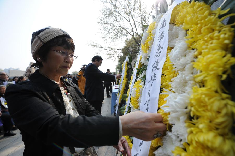 A Japanese woman attends the memorial ceremony in the Memorial Hall of the Victims in Nanjing Massacre by Japanese Invaders, in Nanjing, capital of east China's Jiangsu Province, April 4, 2013, also the Qingming Festival, or the Tomb-Sweeping Day. Lots of citizens came here to mourn Nanjing Massacre victims on Thursday. (Xinhua/Han Yuqing) 