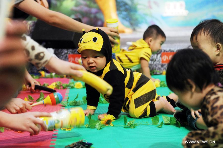 A baby dressed as a bee takes part in a crawl competition held in a shopping mall in Hong Kong, south China, April 4, 2013. Many parents took their children to the event here on Thursday. (Xinhua/Lui Siu Wai) 