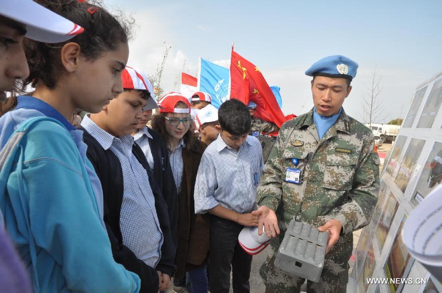 Chinese peacekeepers give a lesson to the local students about mine during an activity to mark the International Day of Mine Awareness and Assistance in Mine Action in Naqoura, southern Lebanon, April 4, 2013. The United Nations Interim Force in Lebanon (UNIFIL) observed Thursday the International Day of Mine Awareness and Assistance in Mine Action at its headquarters in Naqoura, southern Lebanon. (Xinhua/Liu Song)