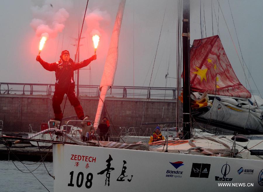 China's Guo Chuan celebrates after returning home in Qingdao, east China's Shandong Province, April 5, 2013. Guo sailed back home on Friday morning to become the first Chinese to successfully circumnavigate the globe singlehanded. Aboard his Class40 yacht, 48-year-old Guo travelled about 21,600 nautical miles in 138 days before he returned to his hometown of Qingdao, where he set off on November 18 last year. (Xinhua/Li Ziheng) 