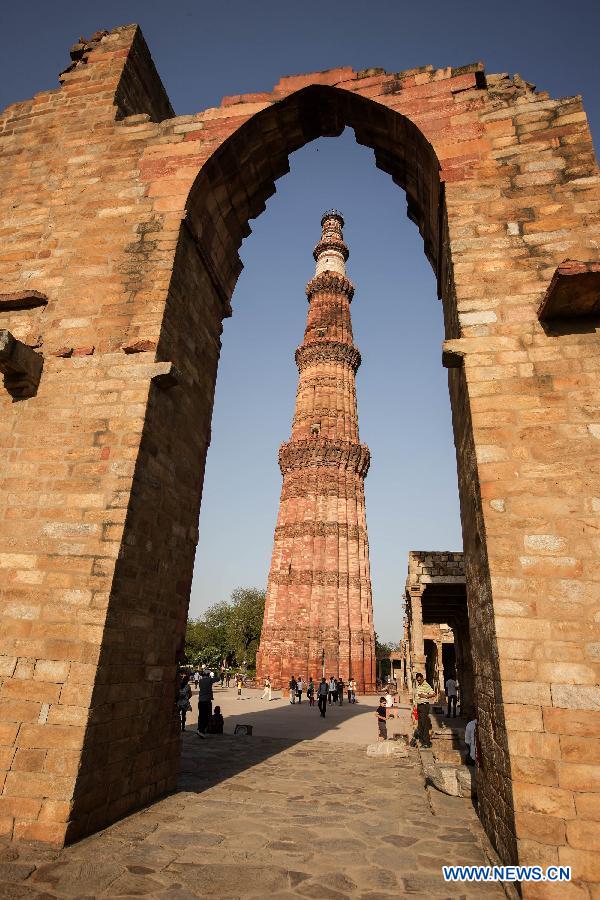 People visit the Qutab Minar in New Delhi, India, on April 5, 2013. Qutab Minar, a UNESCO World Heritage Site, is the tallest minaret in India. It is 75.56 metres high with a base a diameter of 14.3 metres, which narrows to 2.7 metres at the top storey. The minar is made of red sandstone and marble, and covered with intricate carvings. The construction of Qutab Minar started in 1193 by Qutub-ud-din Aibak and was completed by his inheritor Iltutmish. It is surrounded by several other ancient and medieval structures and ruins, collectively known as the Qutub complex, which attracts many visitors till now. (Xinhua/Zheng Huansong)