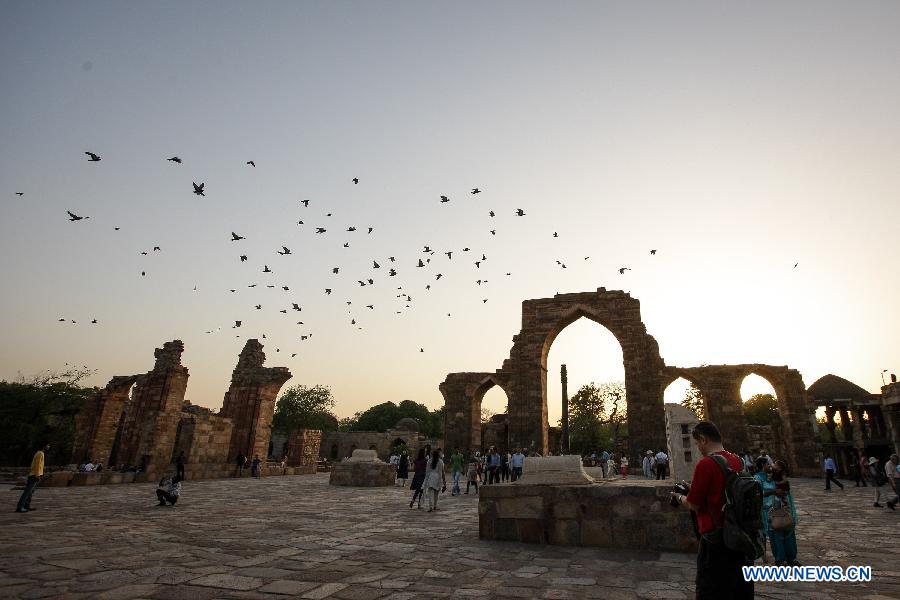 People visit the Qutab Minar in New Delhi, India, on April 5, 2013. Qutab Minar, a UNESCO World Heritage Site, is the tallest minaret in India. It is 75.56 metres high with a base a diameter of 14.3 metres, which narrows to 2.7 metres at the top storey. The minar is made of red sandstone and marble, and covered with intricate carvings. The construction of Qutab Minar started in 1193 by Qutub-ud-din Aibak and was completed by his inheritor Iltutmish. It is surrounded by several other ancient and medieval structures and ruins, collectively known as the Qutub complex, which attracts many visitors till now. (Xinhua/Zheng Huansong)