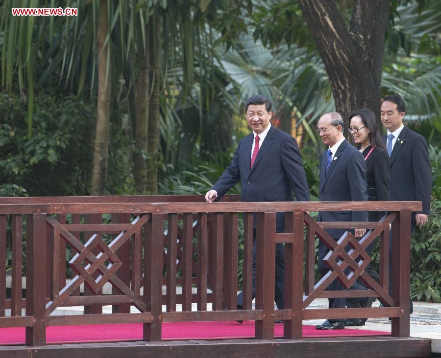 Chinese President Xi Jinping (1st L) and Myanmar's President U Thein Sein (2nd L) walk to a welcoming ceremony to be held by President Xi Jinping for President U Thein Sein in Sanya, south China's Hainan Province, April 5, 2013. (Xinhua/Li Xueren)