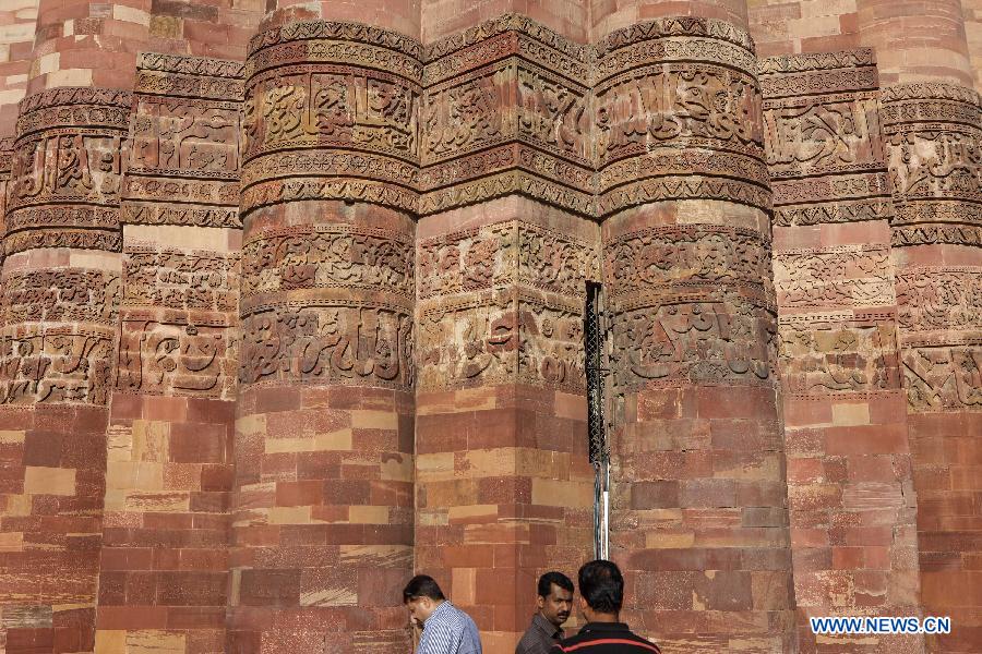 People visit the Qutab Minar in New Delhi, India, on April 5, 2013. Qutab Minar, a UNESCO World Heritage Site, is the tallest minaret in India. It is 75.56 metres high with a base a diameter of 14.3 metres, which narrows to 2.7 metres at the top storey. The minar is made of red sandstone and marble, and covered with intricate carvings. The construction of Qutab Minar started in 1193 by Qutub-ud-din Aibak and was completed by his inheritor Iltutmish. It is surrounded by several other ancient and medieval structures and ruins, collectively known as the Qutub complex, which attracts many visitors till now. (Xinhua/Zheng Huansong)