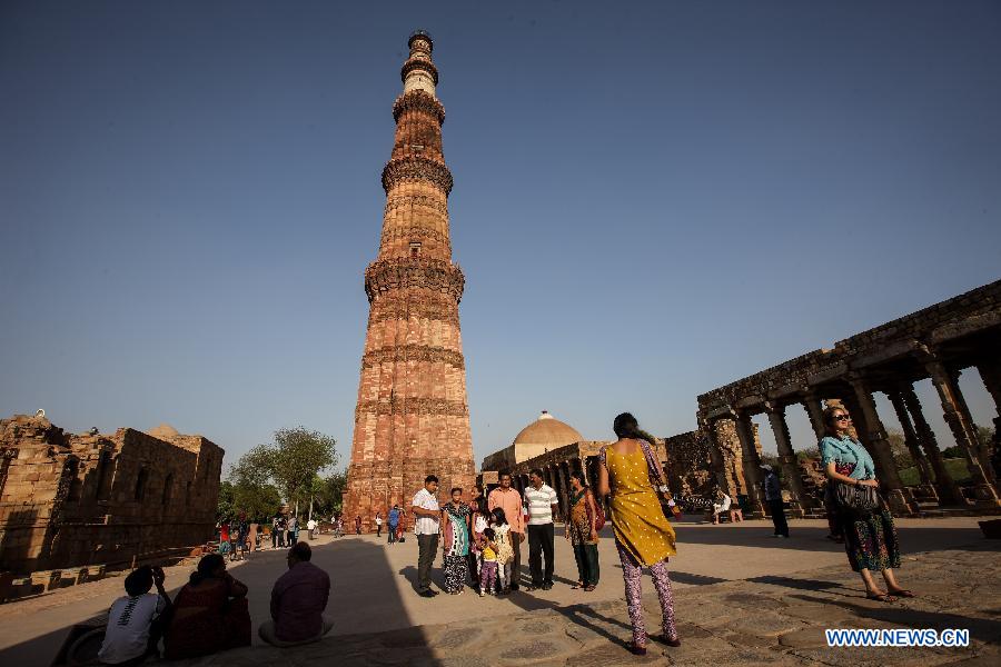 People visit the Qutab Minar in New Delhi, India, on April 5, 2013. Qutab Minar, a UNESCO World Heritage Site, is the tallest minaret in India. It is 75.56 metres high with a base a diameter of 14.3 metres, which narrows to 2.7 metres at the top storey. The minar is made of red sandstone and marble, and covered with intricate carvings. The construction of Qutab Minar started in 1193 by Qutub-ud-din Aibak and was completed by his inheritor Iltutmish. It is surrounded by several other ancient and medieval structures and ruins, collectively known as the Qutub complex, which attracts many visitors till now. (Xinhua/Zheng Huansong)