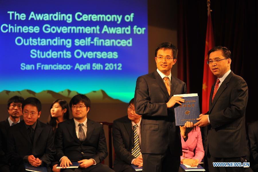 Bi Gang (R), vice consul general of China in San Francisco, award scholarship to a student during the awarding ceremony of Chinese Government Award for Outstanding Self-financed Students Overseas at the consulate general of the People's Republic of China in San Francisco, April 5, 2013. All together 20 students from the University of California at Berkeley, Stanford University, Washington University, University of California at Davis and Washington State University won the scholarship. (Xinhua/Liu Yilin)