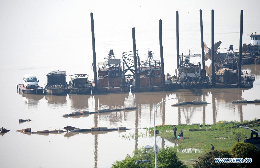 Citizens fish on the bank of the Ganjiang River in Nanchang, capital of east China's Jiangxi Province, April 7, 2013. The water level of the Ganjiang River in the Nanchang segment has risen to 18.53 meters by April 7 morning, five meters higher than half month earlier and two meters higher than the same period of last year, according to the Nanchang Hydrology Station. The local government has strengthened its flood surveillance and control. (Xinhua/Zhou Ke)