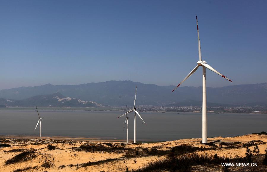 Photo taken on April 7, 2013 shows the Bijiashan Wind Power Plant beside the Poyang Lake in Jiujiang City, east China's Jiangxi Province. The Bijiashan Wind Power Plant, invested by China Power Investment Corporation, has been put into operation with 48 megawatts of installed generating capacity. Currently, there are five wind power plants around the Poyang Lake, respectively Jishanhu, Changling, Daling, Laoyemiao and Bijiashan. (Xinhua/Fu Jianbin)