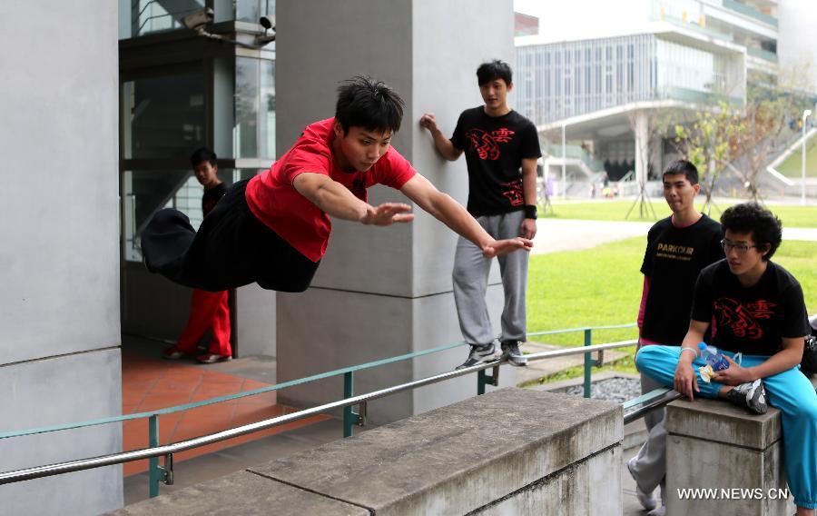 A young man practices parkour at the campus of Taiwan University in Taipei, southeast China's Taiwan, April 7, 2013. Parkour is an activity with the aim of moving from one point to another as efficiently and quickly as possible, using principally the abilities of the human body. (Xinhua/Xie Xiudong)