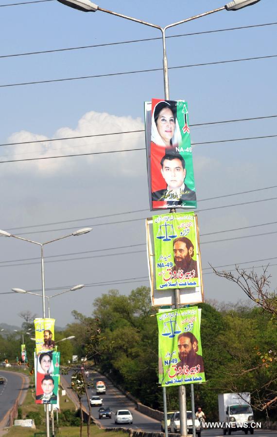 Posters of candidates taking part in the upcoming parliamentary elections are placed on poles in Islamabad, capital of Pakistan on April 7, 2013. (Xinhua/Ahmad Kamal) 