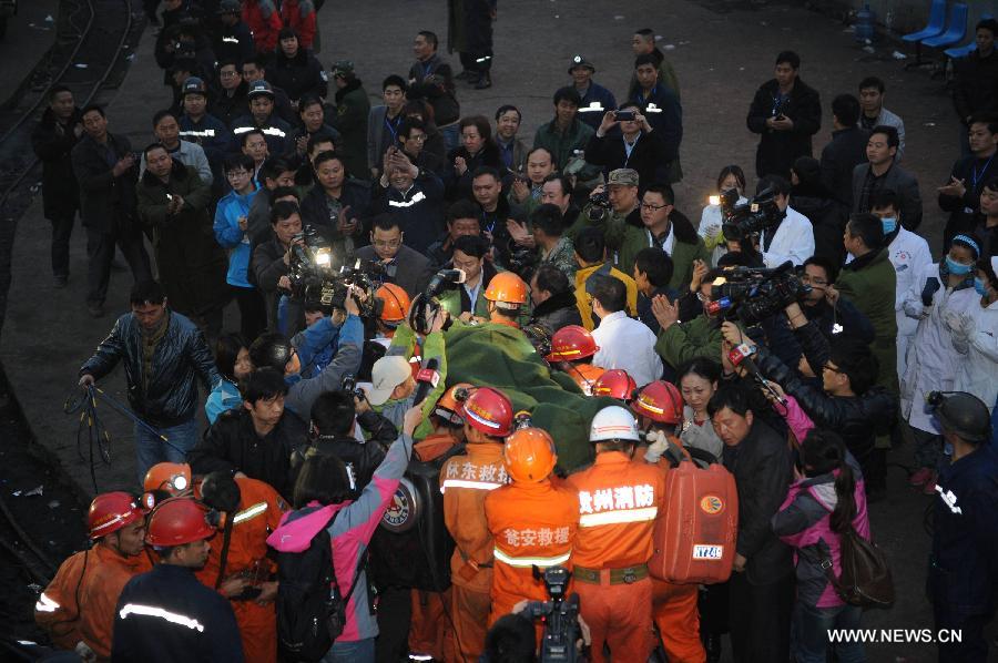 A rescued miner is carried out of the mine shaft of a flooded coal mine in Weng'an County, southwest China's Guizhou Province, April 8, 2013. Three miners trapped in the flooded Yunda Coal Mine for about 60 hours were rescued early Monday morning. Three others remained missing at the mine, which was hit by flood last Friday. Rescuers had earlier confirmed that three miners had been dead. (Xinhua/Liu Xu)